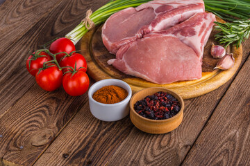 fresh raw new-york steak on wooden Board on wooden background with salt and pepper in a rustic style.