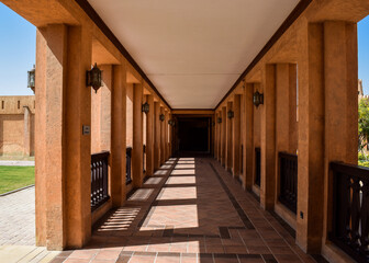 View in perspective of a corridor lined with windows inside Sheikh Zayed Palace Museum. Al Ain, United Arab Emirates.