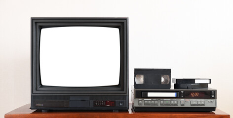 Old black vintage TV with white screen to add new images to the screen, VCR against wallpaper from 1980s, 1990s, 2000s.