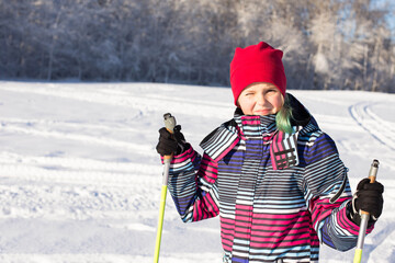 10 year old girl on cross-country skiing. Family sports. Beautiful winter landscape.