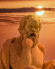 Socrates statue the ancient Greek philosopher illuminated by magic hour dramatic sky, Athens Greece