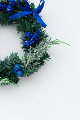 Christmas wreath with blue ribbons on a white background