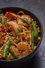 Ramen noodles with shrimp in bowl closeup