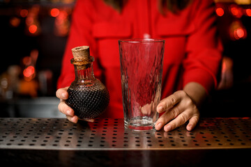 close-up of transparent glass and crystal decanter with wine in woman's hand