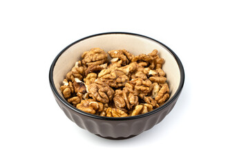 Walnuts in a brown plate on a white background. The concept of useful products.