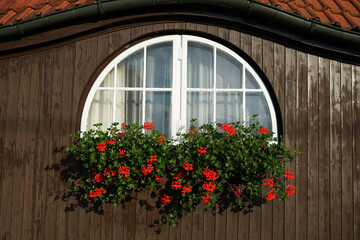Historic building with semi rounded window and flowers