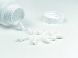 bottle and pills on a white background.