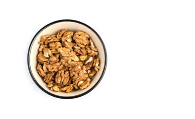 Walnuts in a brown bowl on a white background. Top view with space to copy. The concept of healthy...