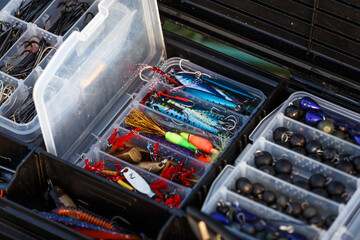 Fishing tackles and fishing baits in box .Classic Colored Fishing Lure , Beautiful Background...