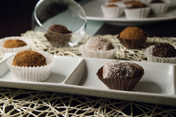 Truffles topped with chocolate or coconut noodles