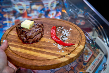 Master chef cooking barbecue Beef Grilled steak meat with fire flames on wooden table