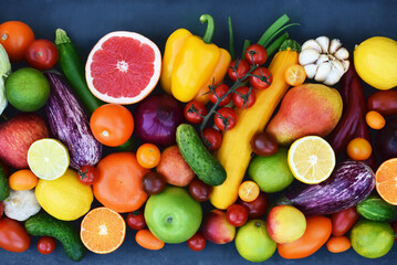 Fresh harvested fruits, greens and vegetables from market: zucchini and orange, tomato and eggplant, apple and pepper, grapefruit and cucumber	