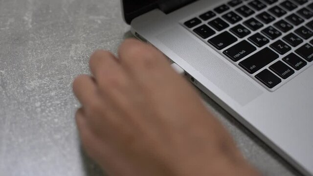 Hand connecting usb hard drive to laptop, modern personal computer technology