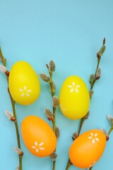 Easter holiday. Easter eggs and pussy willow branches on a  blue  background.Spring festive easter background. Easter symbol.
