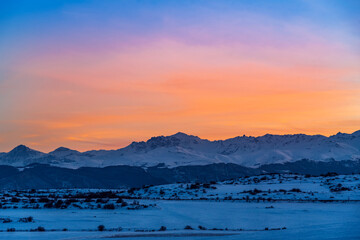Beautiful panoramic sunset over the mountains and  snow-covered hills.
Beautiful panoramic sunset over the mountains and  snow-covered hills.
