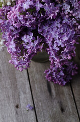 Closeup Purple lilac flowers on a old wooden surface. Spring holidays background.