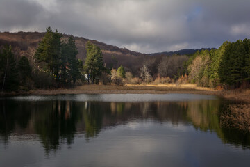 Landscape view of trees with its reflection in the lake. Sliven, Bulgaria