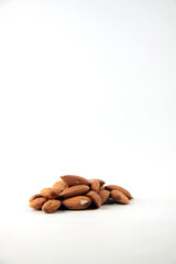 a pile of almond against white background vertical image