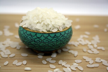 White rice for pilaf on a wooden background.