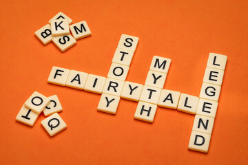 fairytale, story, myth and legend crossword in ivory letter tiles against textured handmade paper, storytelling, folklore and culture concept