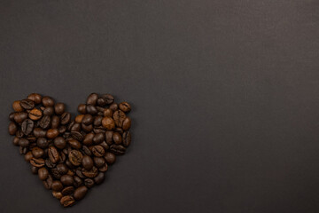 valentines heart made of coffee beans on a dark background