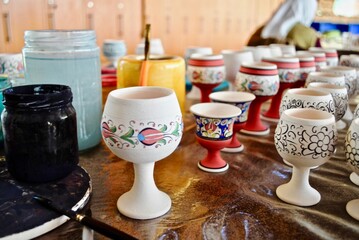 Turkish ceramics being made in Ephesus, Turkey. Black and white floral designs are marked and outlined on gobbles before they are painted. 