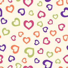 Colorful simple hearts on light yellow background. Seamless love pattern for Valentine day. Suitable for wrapping paper, packaging.