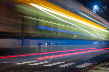 Fototapeta na wymiar Fast-moving tram at the dark Oslo street. 