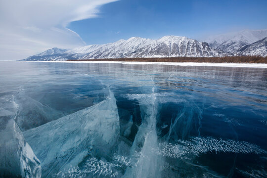 View of beautiful drawings on ice from cracks and bubbles of deep gas on surface of Baikal lake on winter season in Russia