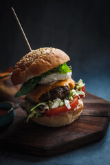hamburger with fries on the wooden board 