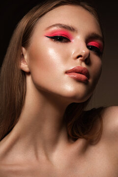 Portrait of a beautiful woman with pink creative make up. Beauty face