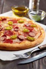 tasty pizza on the wooden background