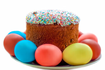 Cake and colored eggs on a platter. Easter lunch. The feast of Holy Easter. Painted eggs.