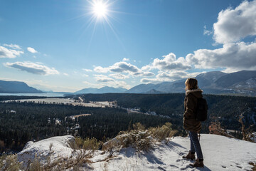 Fototapeta premium Woman looking at view from top of mountain during hike