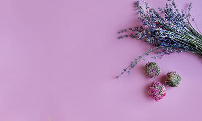 spring composition of dried lavender flowers and flower balls on a pink background with copy space