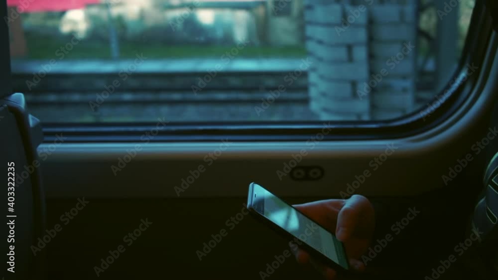 Aufkleber using the mobile application. a man uses a mobile phone in a train carriage. communication of a pers