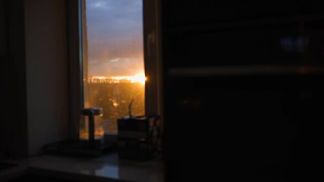 Amazing vivid sunrise or sunset out of window. Moving left revealing shot