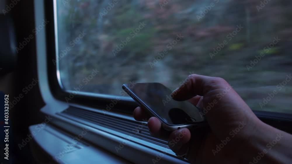 Poster receiving information using the mobile internet in trip. close-up of a hand using a phone in public 