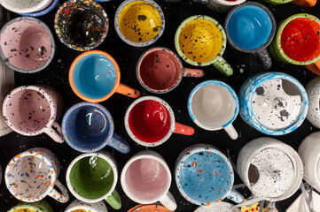 Colorful craft ceramic or pottery mugs, above view
