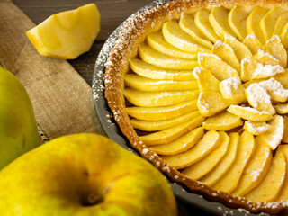 Apple cake with apples on the table