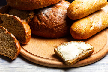 Rye bread and butter sandwich on a wooden table. Still life in rustic style.