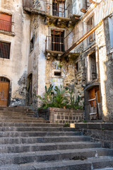Fototapeta na wymiar Old abandoned houses in a staircase road, Castiglione di Sicilia, ITA