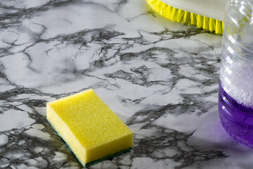 person cleaning objects and table andcleaning supplies
