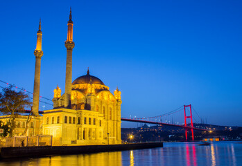 Fototapeta na wymiar Ortakoy Mosque in night lights, in the background the bridge over the Bosphorus, Istanbul, Turkey