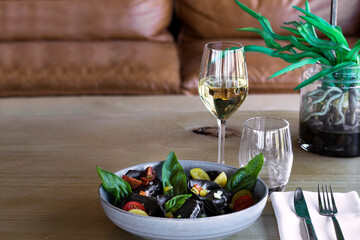 Ravioli, pasta, glass of white wine, sofa