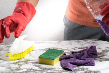 person cleaning objects and table