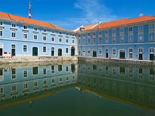 Blue marine administration building mirrors in water