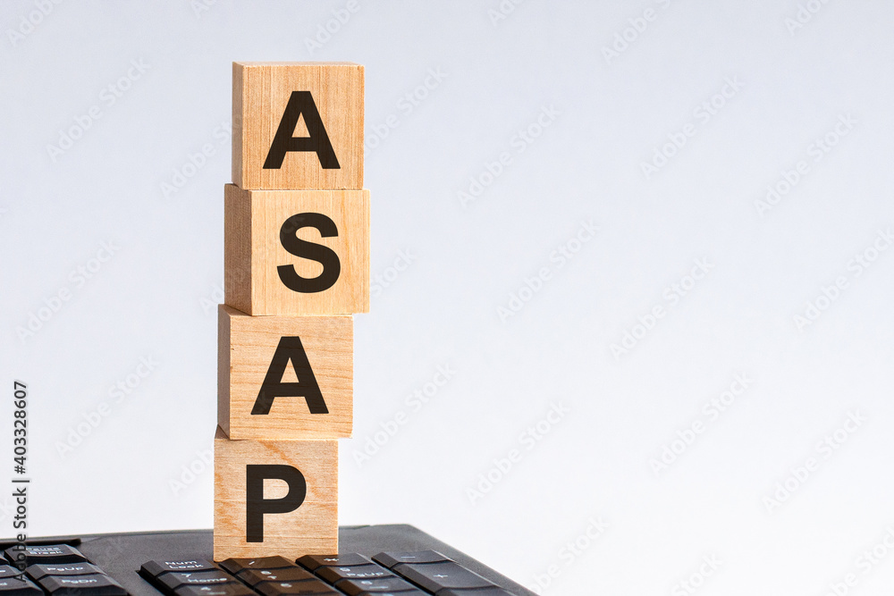 Aufkleber concept image a wooden block and word asap on white background. the cubes are located on the keyboar