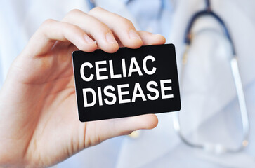 doctor holding a paper card with text CELIAC DISEASE, medical concept