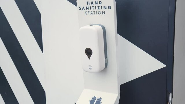Outdoor Hand Sanitiser Station Point in Coronavirus COVID-19 pandemic in 4K. Antibacterial alcohol based disinfectant gel solution for public.